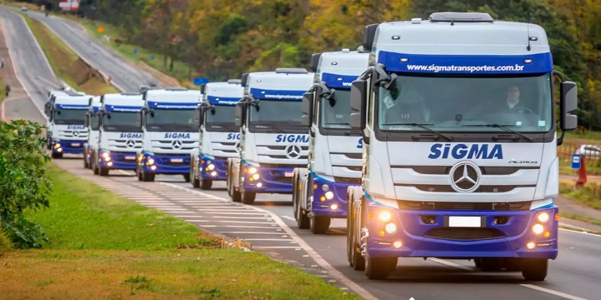 A foto mostra uma frota de carretas da Sigma Transportes